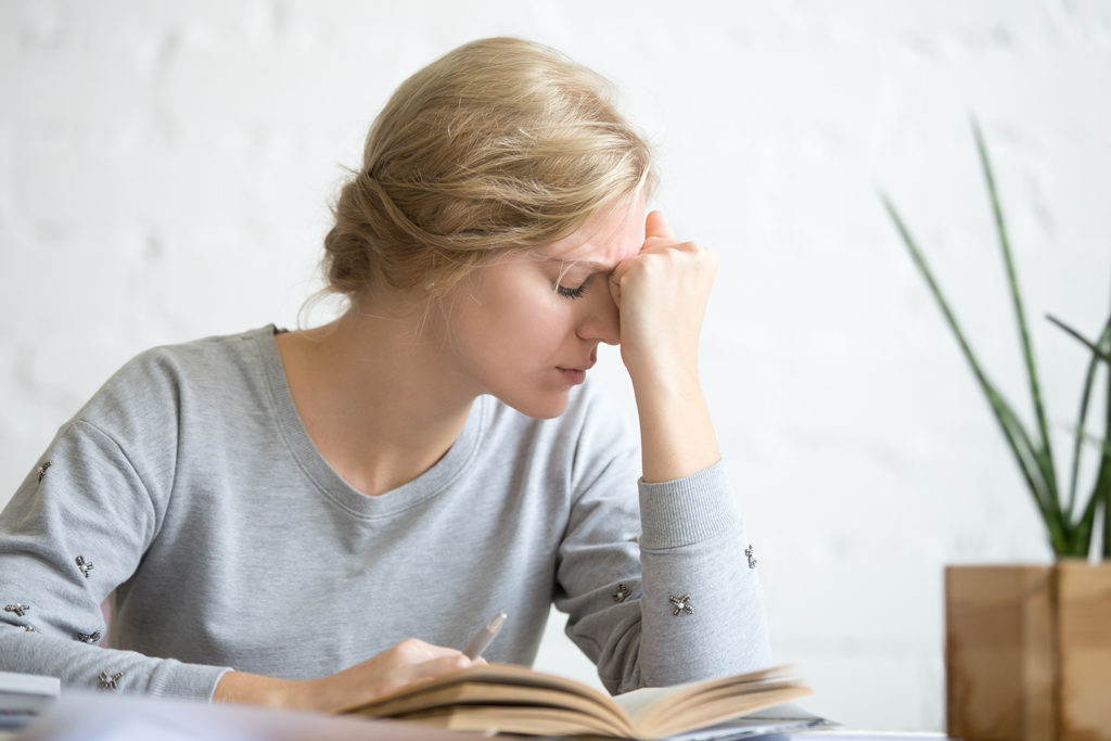 a woman having vertigo after reading