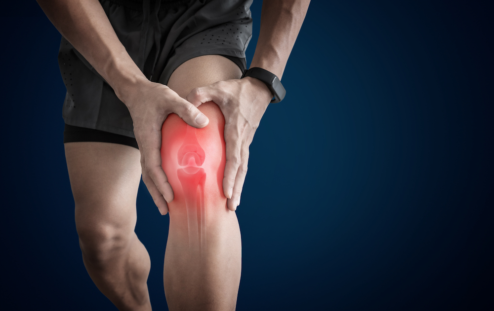a man having a knee pain from overuse injury