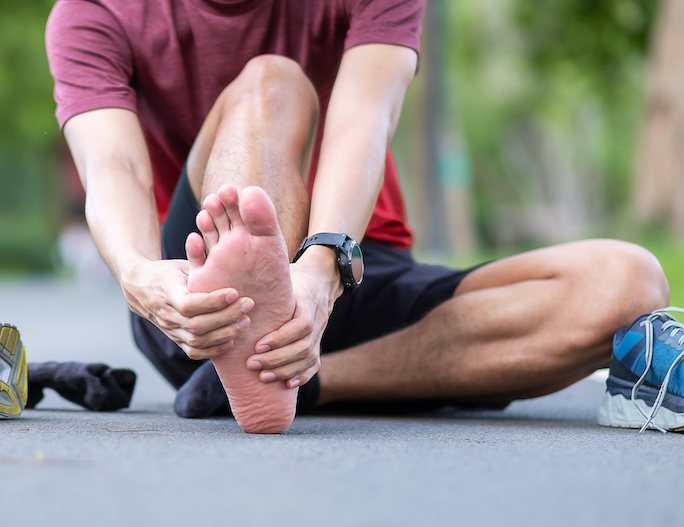 a man having a heel pain from plantar fasciitis after walking