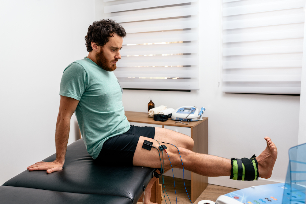 a man having a electrotherapy on a leg