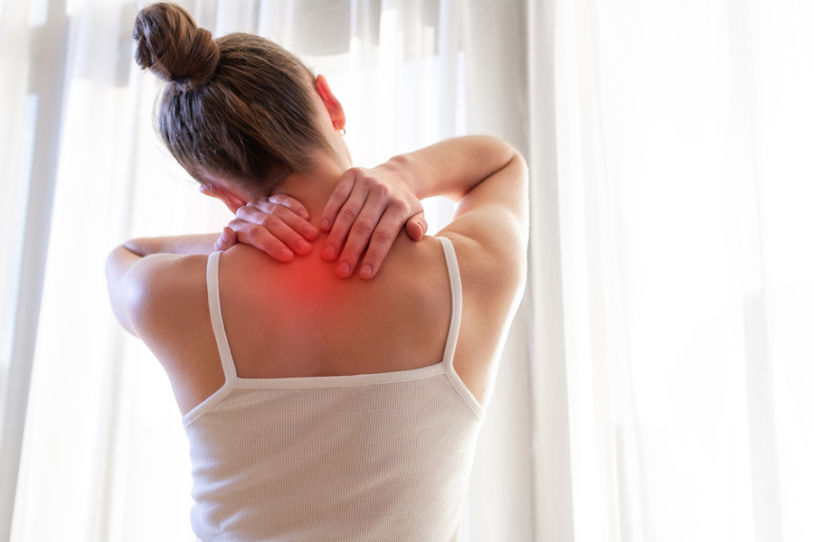a woman suffering from neck pain