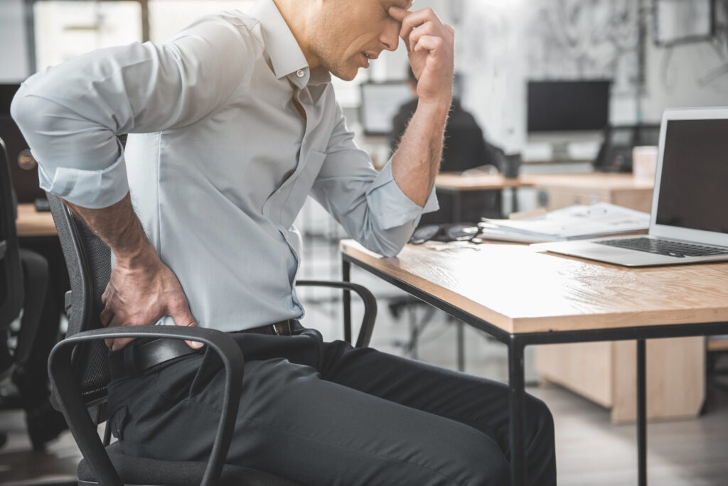 a man suffering from lower pain after his work